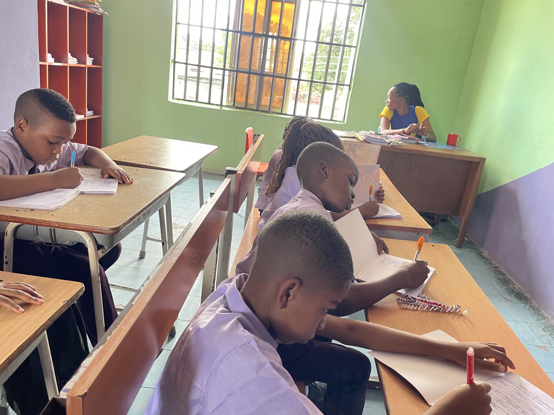 Pupils writing at their desks during a lesson at Royal Excellentia International School